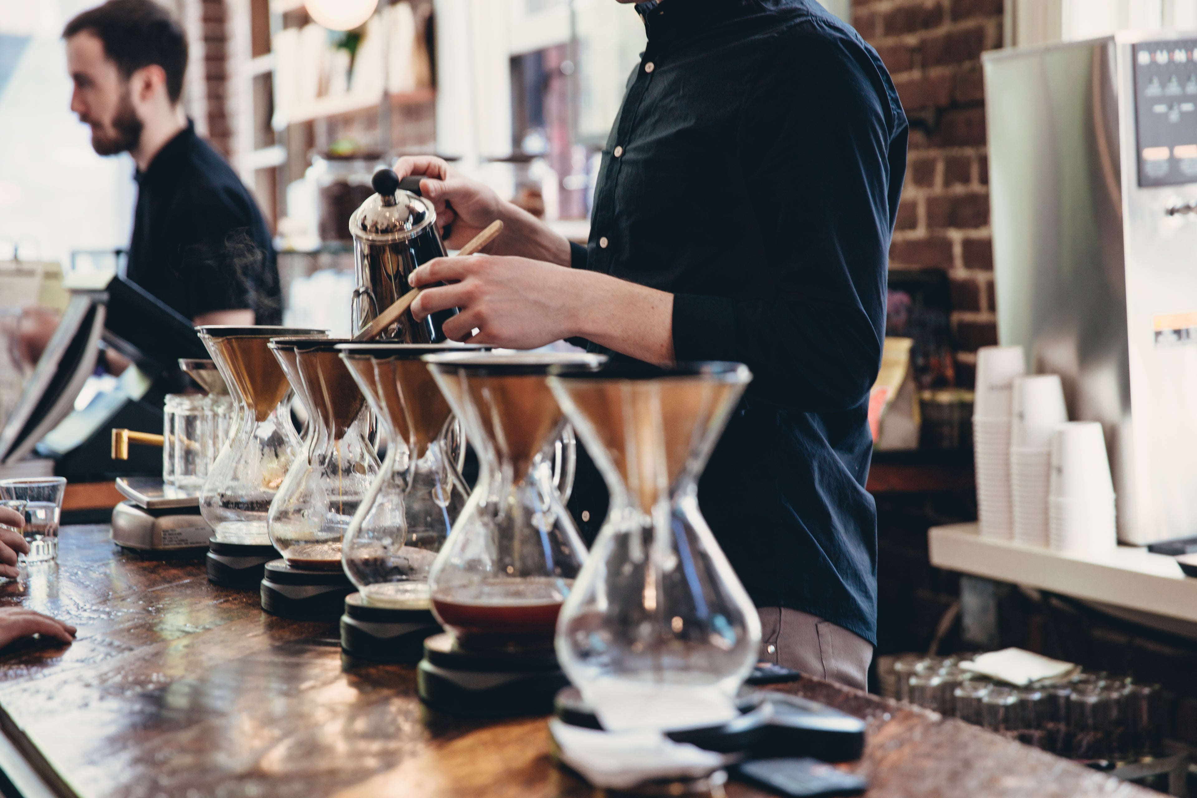 Barista brewing coffee with filter